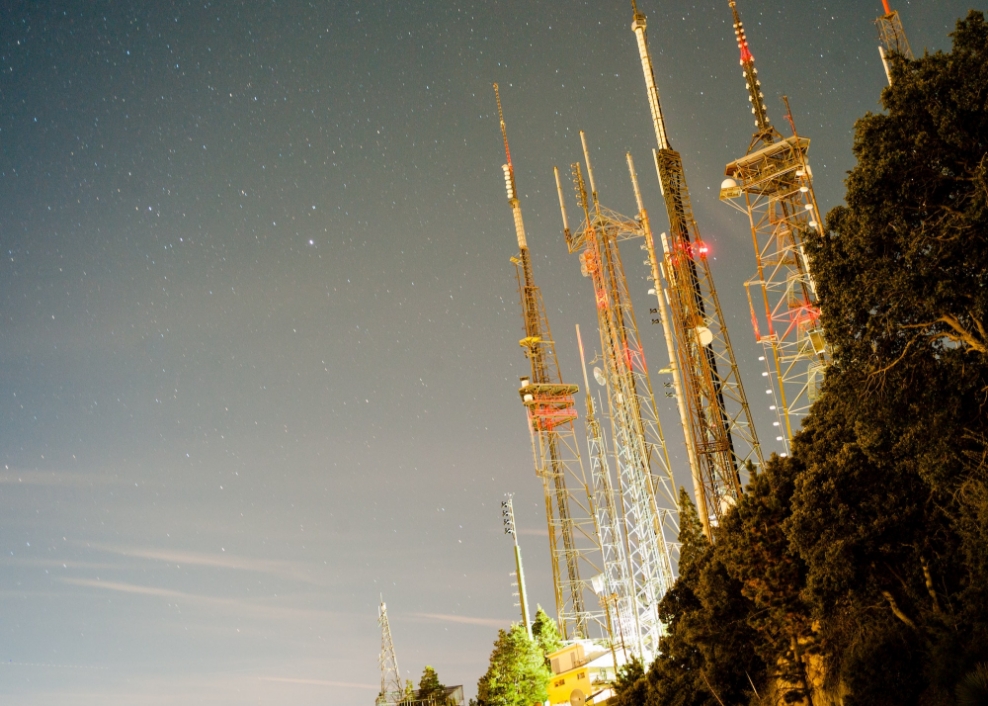 Night photograph of antennas on mountainside
