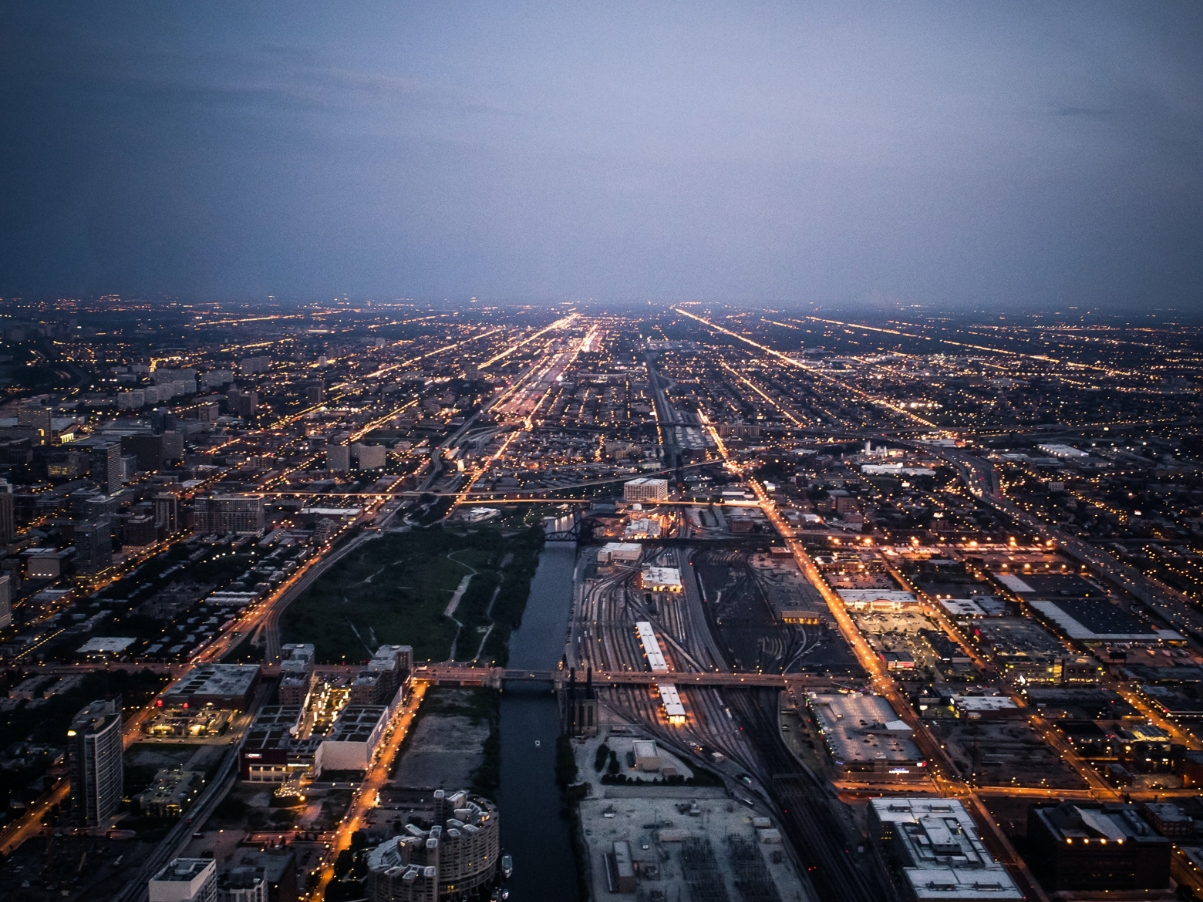 Photograph over a city lit-up with lights at dusk