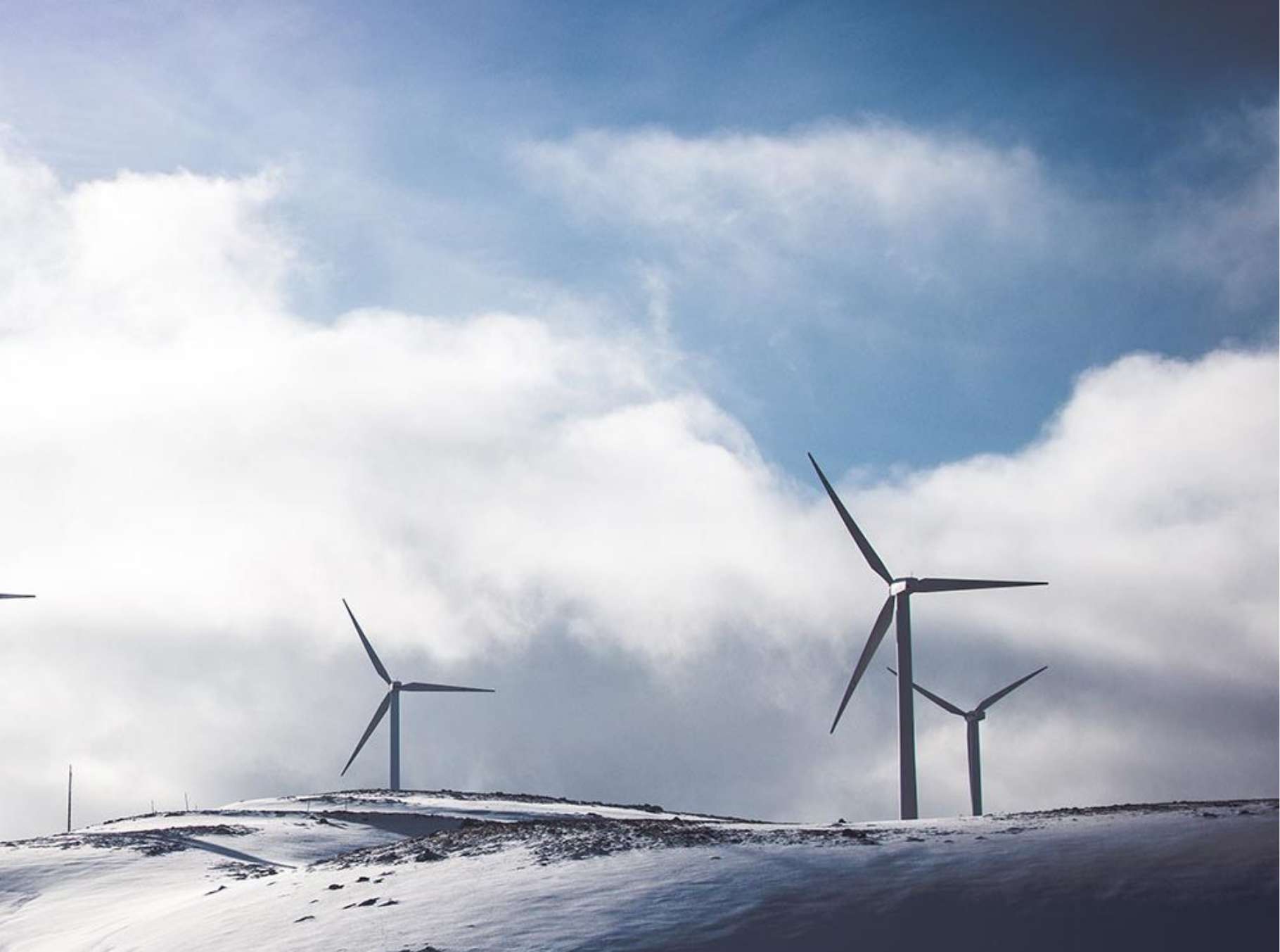 Photograph of windmills on a snowy hill